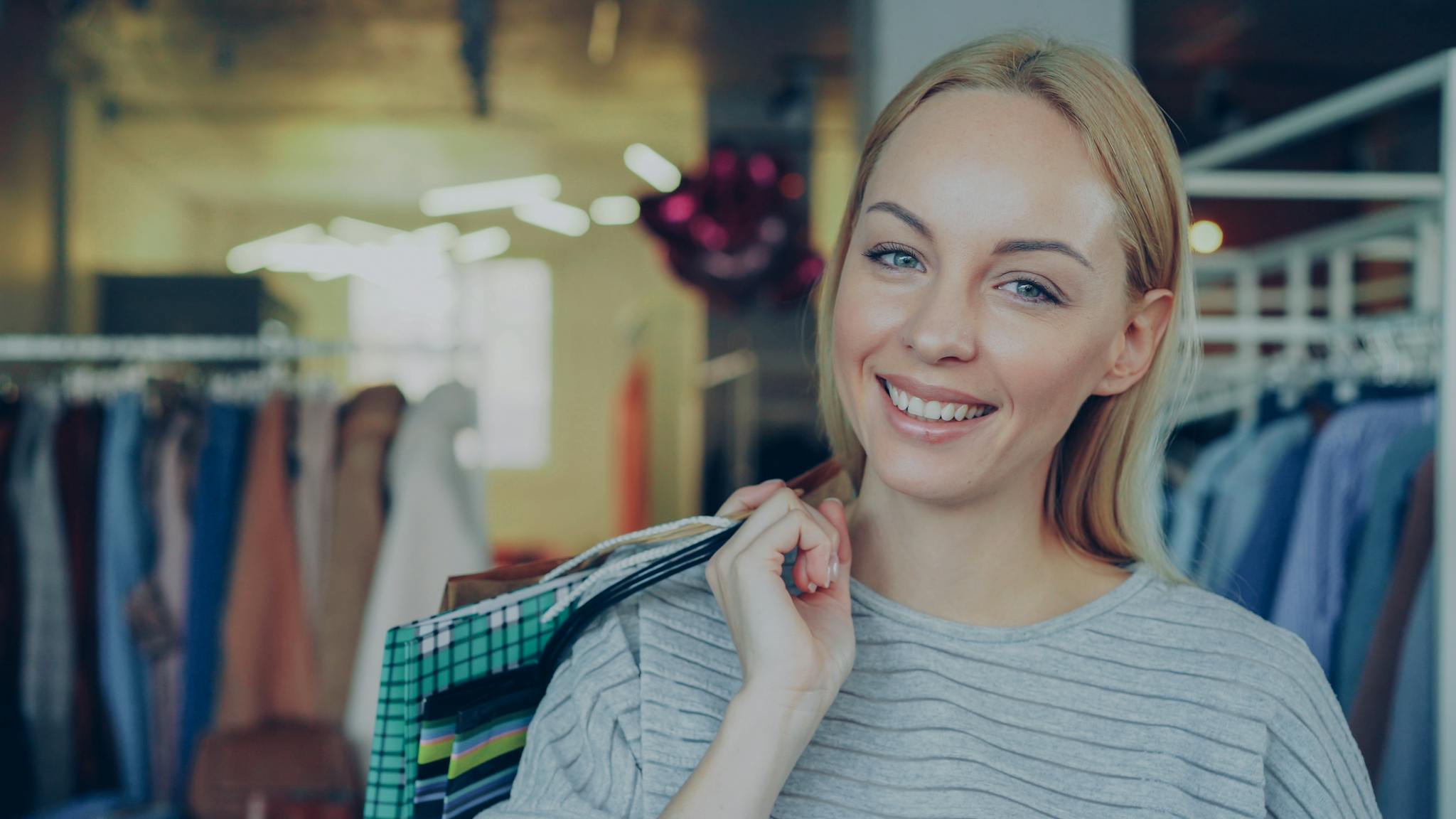 Delighted Woman Shopping In A Stylish Boutique