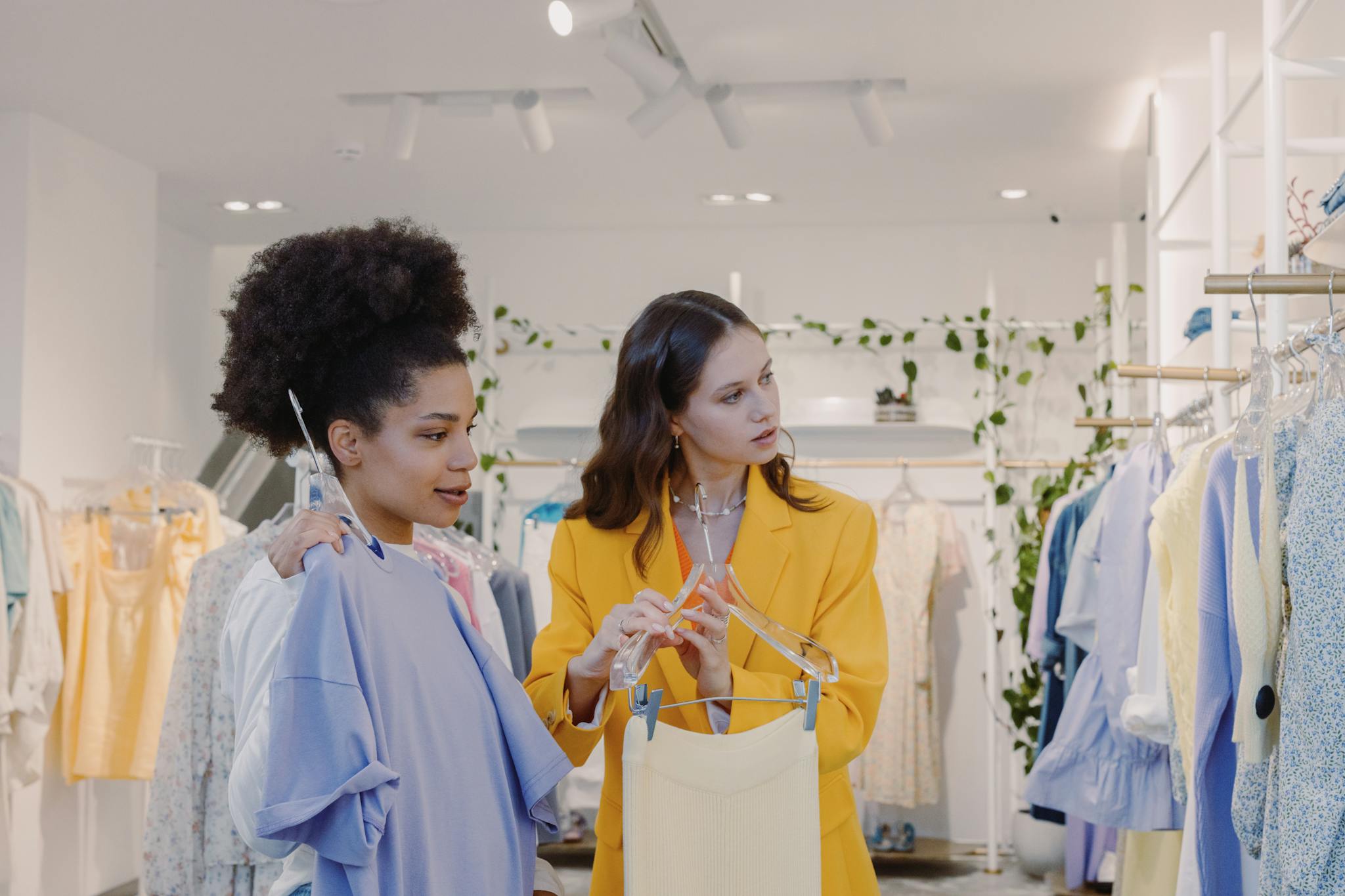 Two Women Shopping For Trendy Clothes In